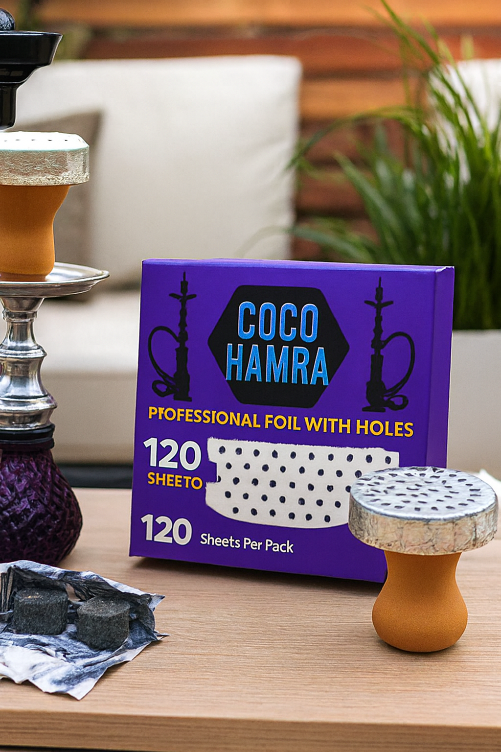 Coco Hamra hookah foil packaging with a shisha setup on a table.