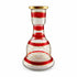 Decorative glass hourglass with red and gold stripes on a white background