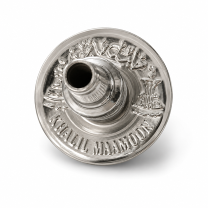 A polished silver metal teapot lid or insert with engraved Arabic calligraphy and the words &