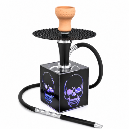 A black hookah set with a glossy cube base featuring illuminated purple skull graphics, a black patterned head ring, a terracotta-colored bowl, and a black hose with a silver-and-black mouthpiece, shown on a white background.