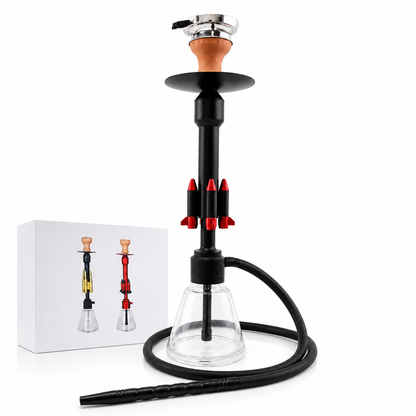 A modern hookah set featuring a black metal stem with red accents, a clear glass bowl, a black hose, and a silver mouthpiece with a brown mouthpiece. A white product box is shown in the background on a clean white studio backdrop.