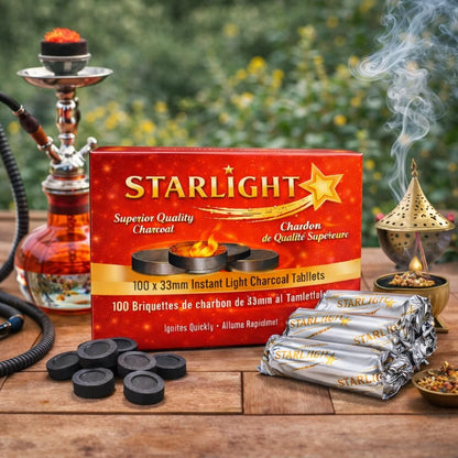 Starlight brand instant light charcoal tablets shown with their red retail box, wrapped silver packets, loose black tablets, and smoking incense on a wooden table with a hookah and incense burner in a garden setting.